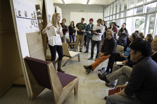 Students presented their finished chair designs one-by-one to a panel of reviewers and fellow students.