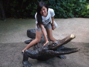 Nicole “taming” an alligator in Singapore in 2011.