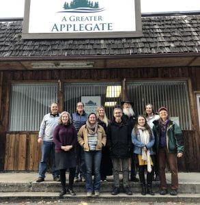 Group of happy people posed in front of the new building for A Greater Applegate
