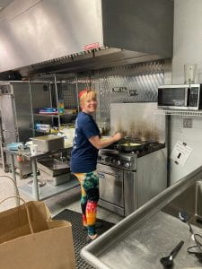 Image of Mae in a kitchen helping cook