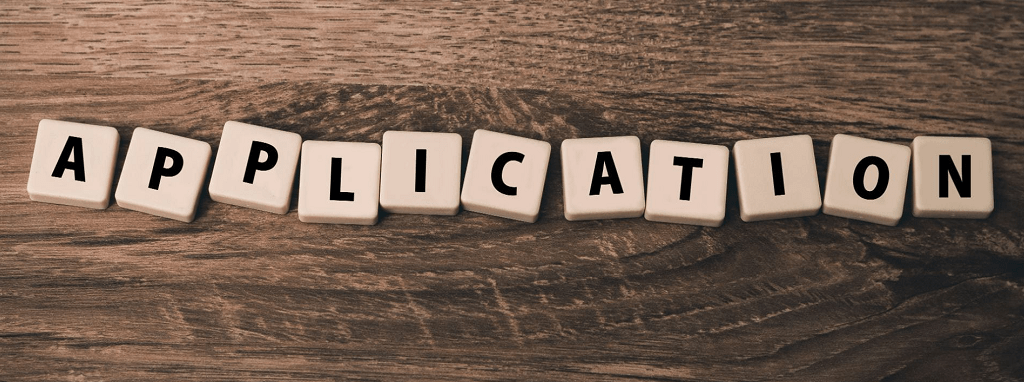 Tiled letters arranged to spell "application."
