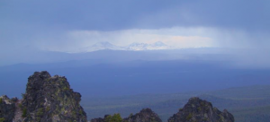 Views of the Cascades, the Tree Sisters volcanos, from the rim of the Newberry caldera looking west through thunder storms