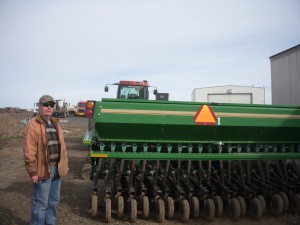 Paul Bates showing wheat farm equipment; photo courtesy of Nancy Nusz