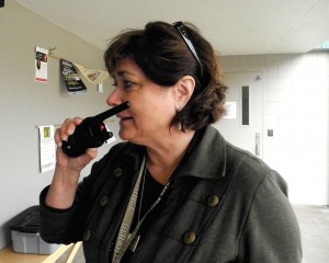 Close up of Londa Roccholz communicating with fellow staff using a walkie-talkie