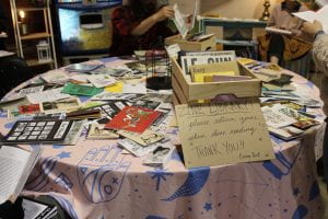 zines and box of zines on table