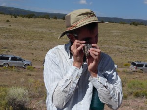 Sam, USGS Mendenhall Fellow, gets up close an personal with some Treasure Mountain vitrophyre